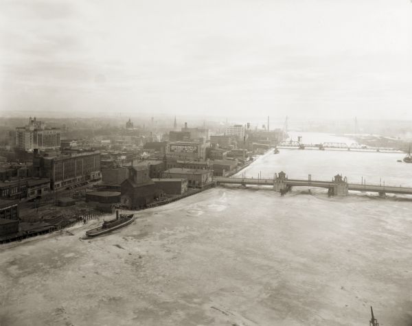 Aerial view of Green Bay, including the Jorgensen-Blesch Company building and two bridges.