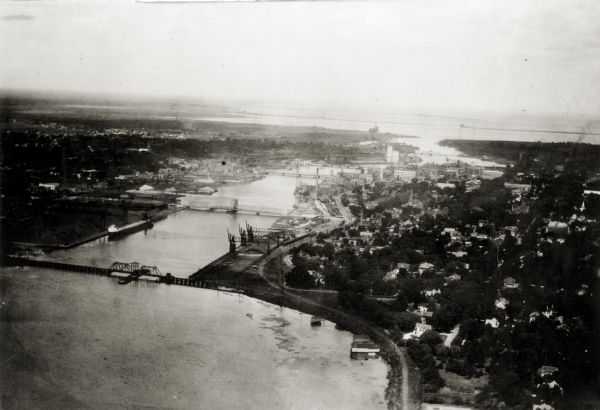 Aerial view of with bridges, river, and shoreline.