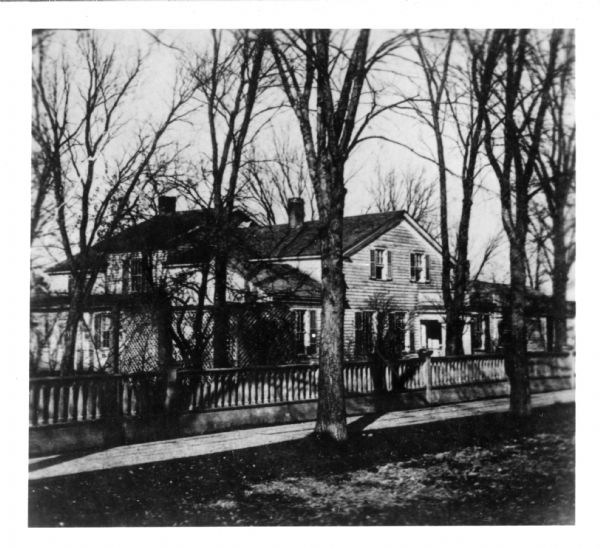 View of the H.E. Eastmen residence. The house was located on the southwest corner of Porlier and Monroe Streets, and later the residence of Mrs. George G. Green was built there.