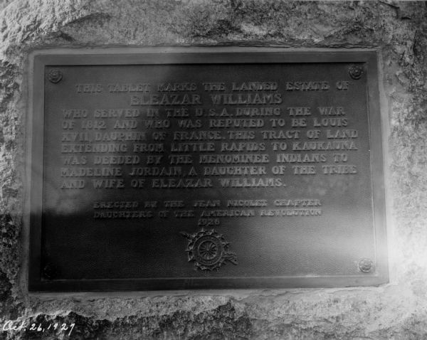 View of a plaque mounted on a stone.