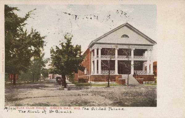 View from street toward the building on the corner. There is a horse-drawn carriage at the curb. Caption reads: "Elks Club House, Green Bay, Wis."