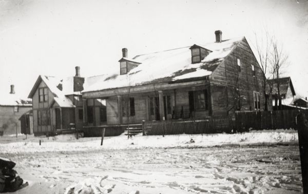 View of the barracks on at the edge of a snow-covered street.