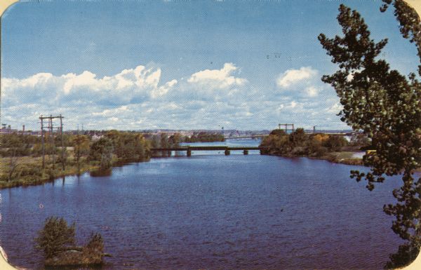 Elevated view of the Fox River. A bridge is in the distance.