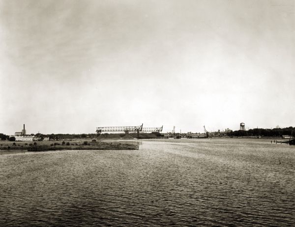 View of the Fox River. The Green Bay Drop Forge Company are on the left, and the Reiss coal yard is in the distance in the center.