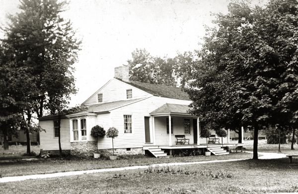Exterior view of the Tank cottage before restoration on its original site. The cottage was built in 1776 by Joseph Roi, a fur trader, who lived in it until 1805 when it was purchased by Jacques Porlier. Later, the Tank family, who presented Tank Park to the city, lived in it. In recent years, the Brown County Historical Society and the South Side Improvement Association have rescued it from an industrial section of the city and taken it to Tank Park, where it now stands.