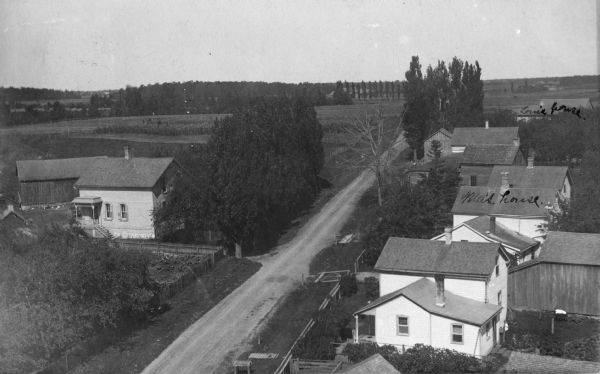 Elevated view of homes alongside a road in Hika (also known as Centerville). Handwritten on two of the buildings on the right are: "Ma's house." and "Louis(?) house."