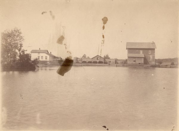 View across water towards the Hull mill (right), showing Merlin Hull's ancestral home at left.