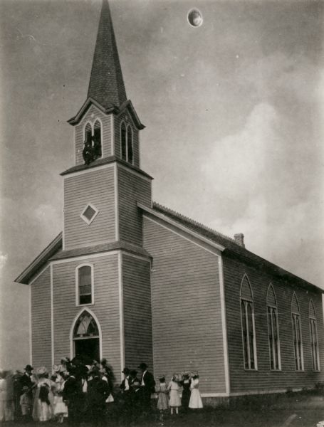 Exterior of the Old York Church. A group of people are standing around the entrance. The church was built in 1861 and destroyed in 1977.