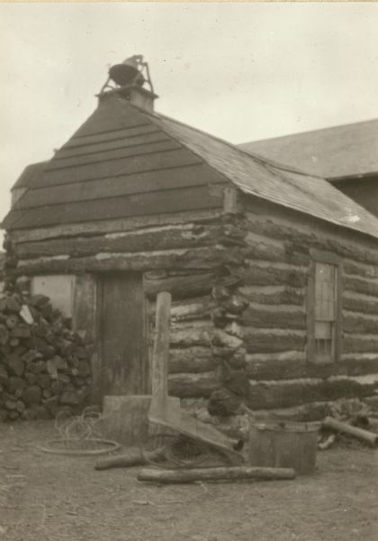 The York log school house was built in 1843. It was later used on the Pelty farm as a workshop. There is a bell on the roof.