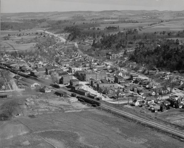 An aerial view of Wonewoc showing central businesses and a railroad.