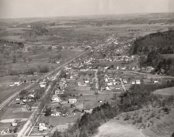 Aerial view of Wonewoc with hills or bluffs in the foreground on the right.