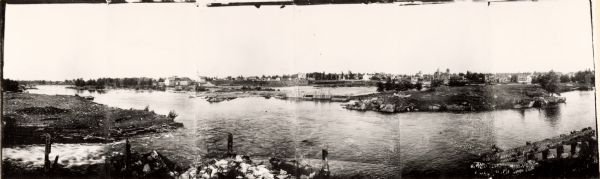 A panoramic view of the east bank of the Wisconsin River from the Green Bay & Western Railway bridge to the wagon bridge.