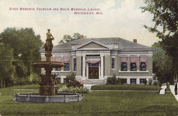 View towards the fountain on the lawn in front of the library. Pedestrians are on the right. Caption reads: "Birge Memorial Fountain and White Memorial Library, Whitewater, Wis."