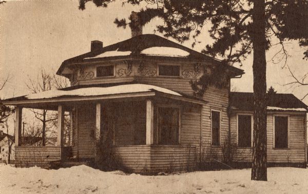 The octagon house. Text on back reads: Whitewater's octagon house is a frame one which dates back to 1855. The porch was added only a generation ago, the kitchen addition some years earlier."