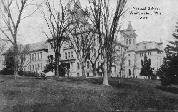 Large trees grace the lawn of the State Normal School located on Main Street. Albert Salisbury, the first president of the school, envisioned the campus as an arboretum to include "every species of tree or shrub that will endure this climate." Caption reads: "Normal School, Whitewater, Wis."