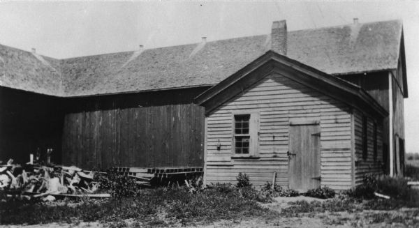 The Westport School attended by Ella Wheeler. It is now used as a tool shed. A large barn is behind the smaller building.