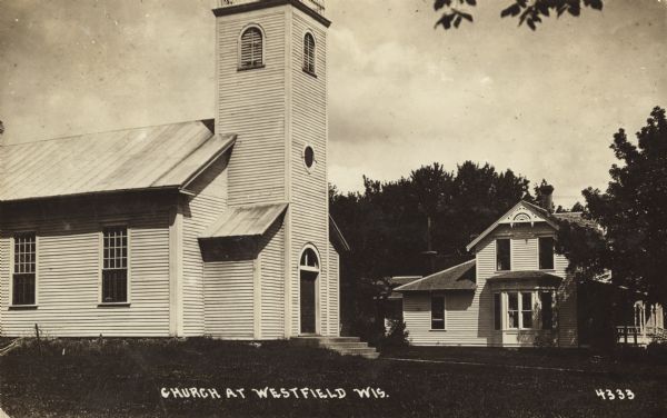 View toward the church on the left. Another building is in the background on the right. Caption reads: "Church at Westfield, Wis."