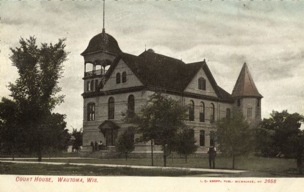 View towards the court house. A man is standing on the right near the sidewalk. Caption reads: "Court House, Wautoma, Wis."