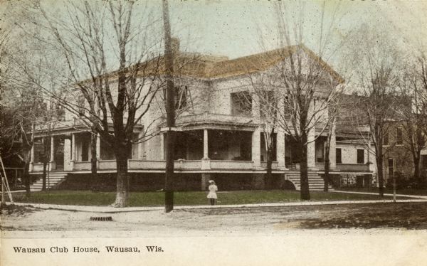 View across intersection toward the Wausau Club House which has a wrap-around porch, and steps on two sides. There is a little girl standing on the sidewalk in front of the building. Caption reads: "Wausau Club House, Wausau, Wis."