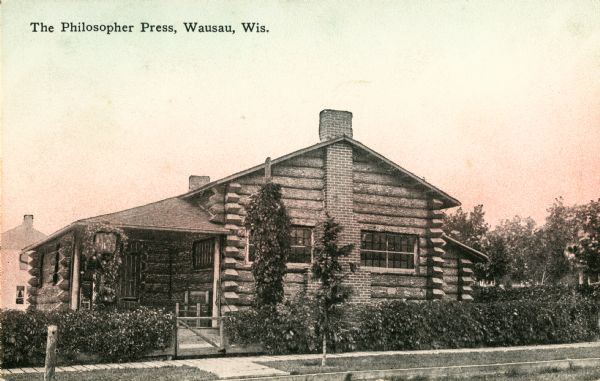 Exterior view of the log building. Caption reads: "The Philosopher Press, Wausau, Wis."
