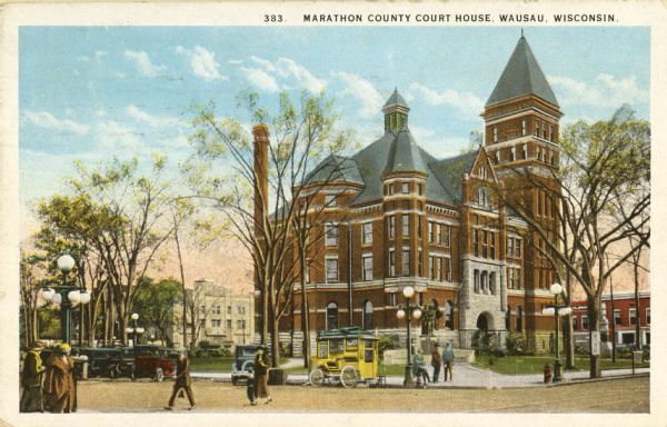 View across intersection toward the courthouse. Cars and pedestrians are in the streets and on the sidewalks. Caption reads: "Marathon County Court House, Wausau, Wis."