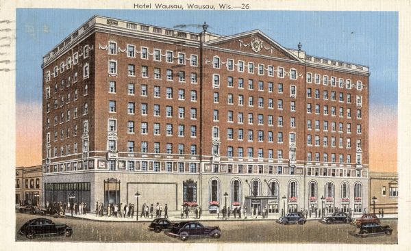 View of the Hotel Wausau on a street corner, with pedestrians on the sidewalks, and automobiles in the street. Caption reads: "Hotel Wausau, Wausau, Wis."