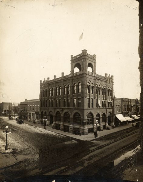 Elevated winter view of the First National Bank, with Dunbar Co. Jewelers and a chiropractor business to the left.
