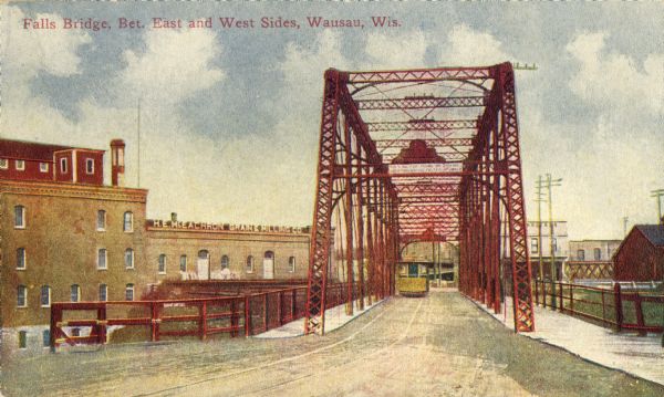 View of the Falls Bridge and surrounding buildings. Caption reads: "Falls Bridge, Bet. East and West Sides, Wausau, Wis."