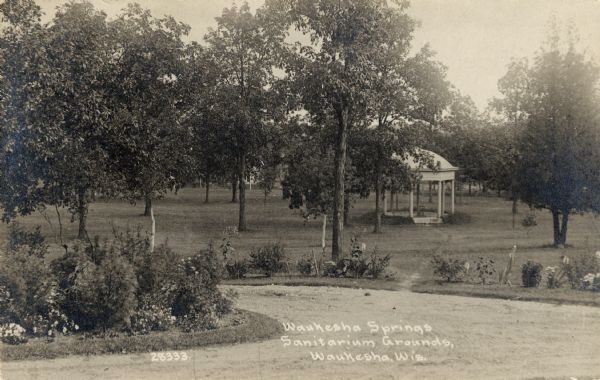 View of the grounds of Waukesha Springs Sanitarium. Caption reads: "Waukesha Springs Sanitarium Grounds, Waukesha, Wis."