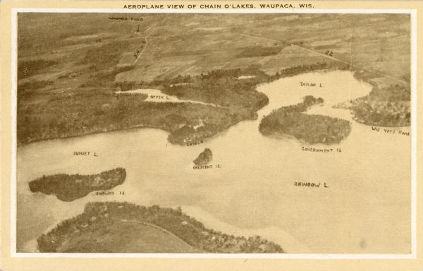 Aerial view of some of the 26 lakes known collectively as the Chain O' Lakes. Caption reads: "Aeroplane View of Chain O'Lakes, Waupaca, Wis."