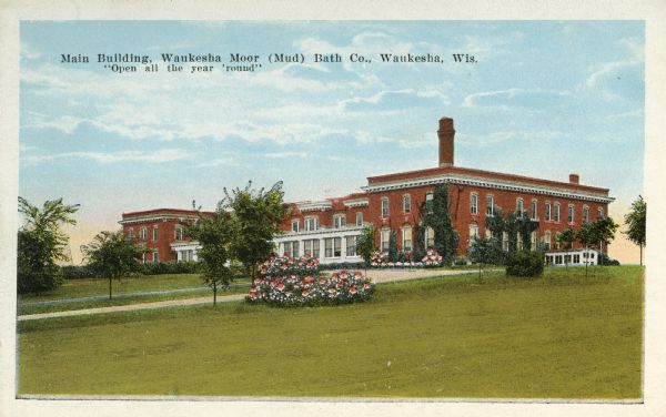 View of the main building of the Moor (Mud) Baths. Caption reads: "Main Building, Waukesha Moor (Mud) Bath Co., Waukesha, Wis. 'Open all the year 'round.'"