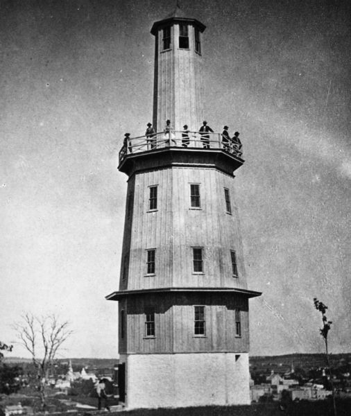 View of Spence's observation tower. There is a group of people standing on its upper balcony.