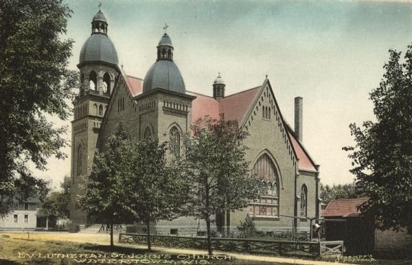 Exterior view of St. John's Evangelical Lutheran Church. Caption reads: "Ev. Lutheran St. John's Church, Watertown, Wis."