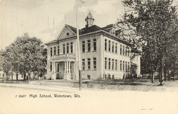 Exterior view of the high school located on East Main Street. Caption reads: "High School, Watertown, Wis."