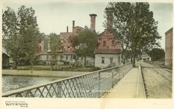 View from bridge towards Hartig's Brewery on the left. Caption reads: "Greetings from Watertown, Wis."