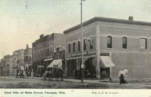 View of the east side of Main Street, featuring a book and stationery store and a pool hall. Caption reads: "East Side of Main Street, Viroqua, Wis."