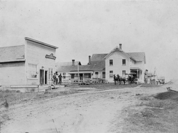 View of several buildings and horse-drawn stagecoaches in Vesper.