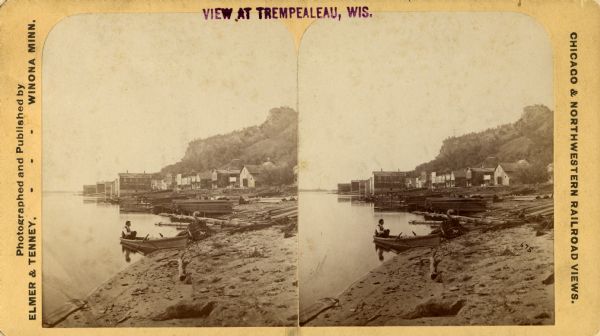 Stereograph of Trempealeau from the river with two men in a boat in the foreground.