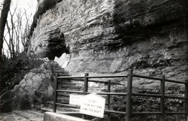 The top of the shot tower shaft with the entrance. The sign on the railing reads: "Do Not Throw Anything Down This Shaft".