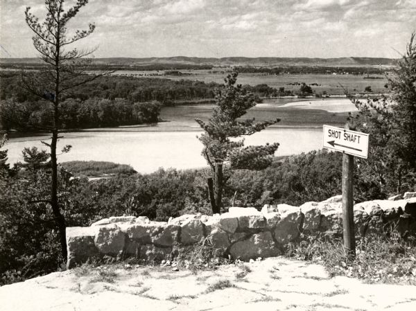 A view from a bluff on Tower HIll overlooking the Wisconsin River. A sign on the right reads: "Shot Shaft".