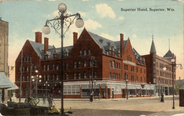 View across street toward the Superior Hotel on a street corner. Caption reads: "Superior Hotel, Superior, Wis."