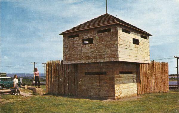 View of a stockade and blockhouse replica built on the site of the original stockade erected in 1862 during a small Sioux Indian uprising in nearby Minnesota.