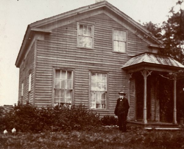 Petherick Sharp house, between Token Creek and Sun Prairie.  Occupied by the Thompson family in the 1930s.  William J. Petherick is standing in front of the house.