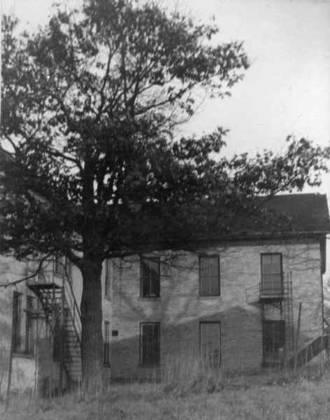 View of the west side of the first school building on the hill.