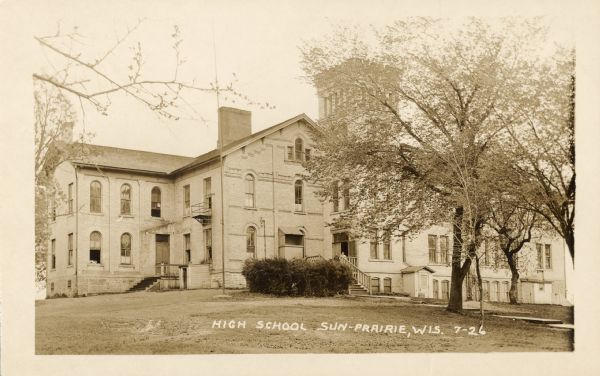 Exterior view of a high school. Caption reads: "High School, Sun Prairie, Wis."