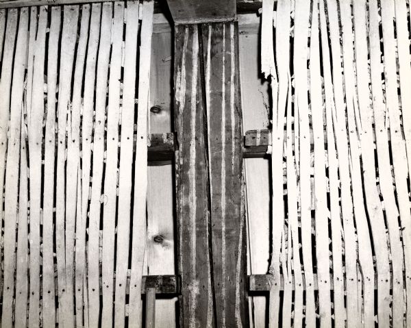 A detailed view of the split lath boards, thin boards nailed to the walls of a house so that plaster may be applied to create the interior wall, in the Doty house.
