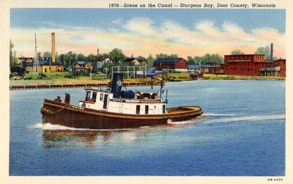 Canal scene with a tugboat featured in the foreground and buildings on the opposite shoreline. Caption reads: "Scene on the Canal — Sturgeon Bay, Door County, Wisconsin."