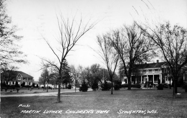 Exterior view across lawn towards the Martin Luther Children's Home. Caption reads: "Martin Luther Children's Home, Stoughton, Wis."