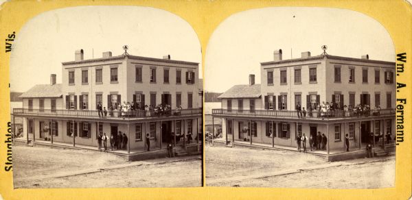 Stereograph view of the Hutson House, with people standing on its balcony and porch.