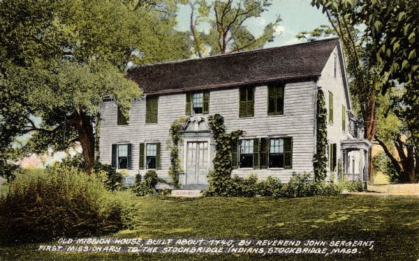Exterior view across yard toward the mission house. Caption reads: "Old mission house built about 1740 by Reverend John Sergeant, first missionary to the Stockbridge Indians, Stockbridge, Mass."